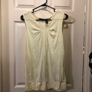 Sleeveless yellow top with beaded neck